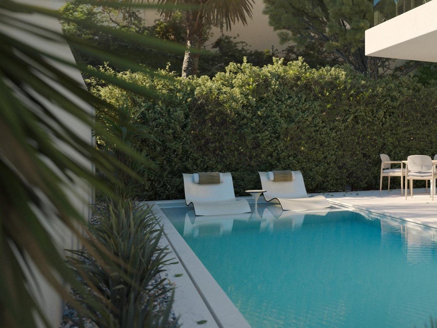 Palms and hedging over still pool water